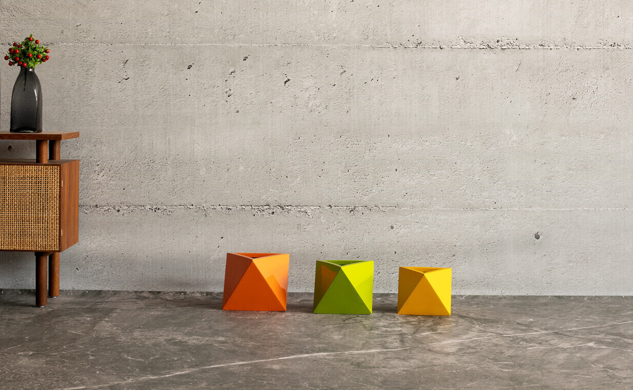 aria fiberglass planter in a triangular shape can be used as an indoor planter is manufactured by Bonasila planters